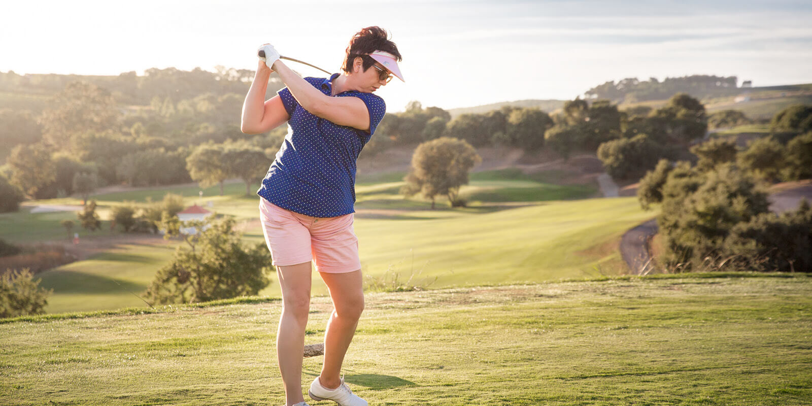 A woman about to swing a golf club