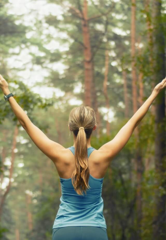 Person stretching in a forest